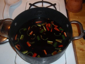 Reducing Broth, Pomegranate Juice and Sugar Mixture with Peppers